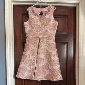 Beautiful pink brocade dress with beaded neckline in like new condition.